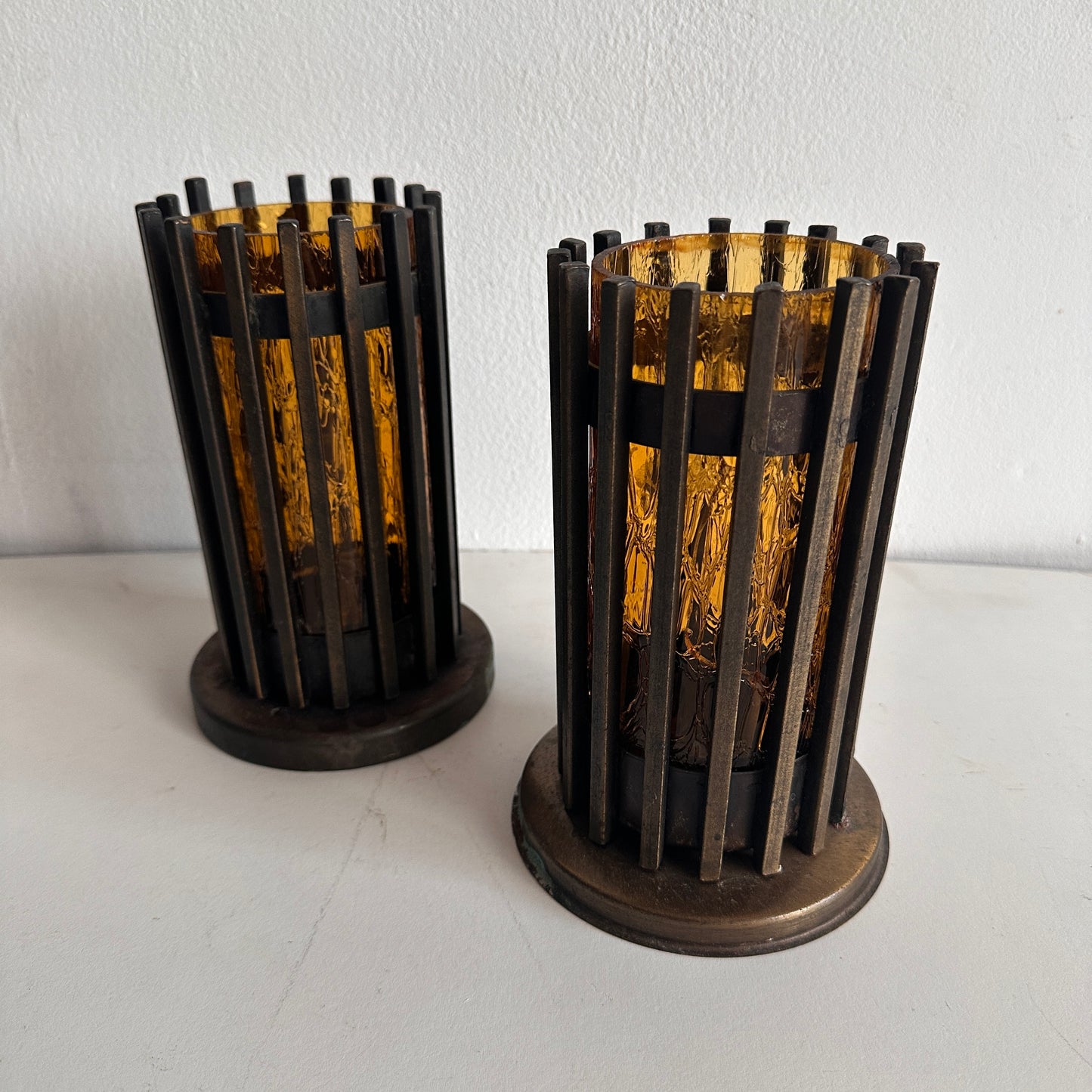 CA012 SET OF TWO BRUTALIST IRON AND AMBER TINTED GLASS PILAR CANDLE HOLDERS