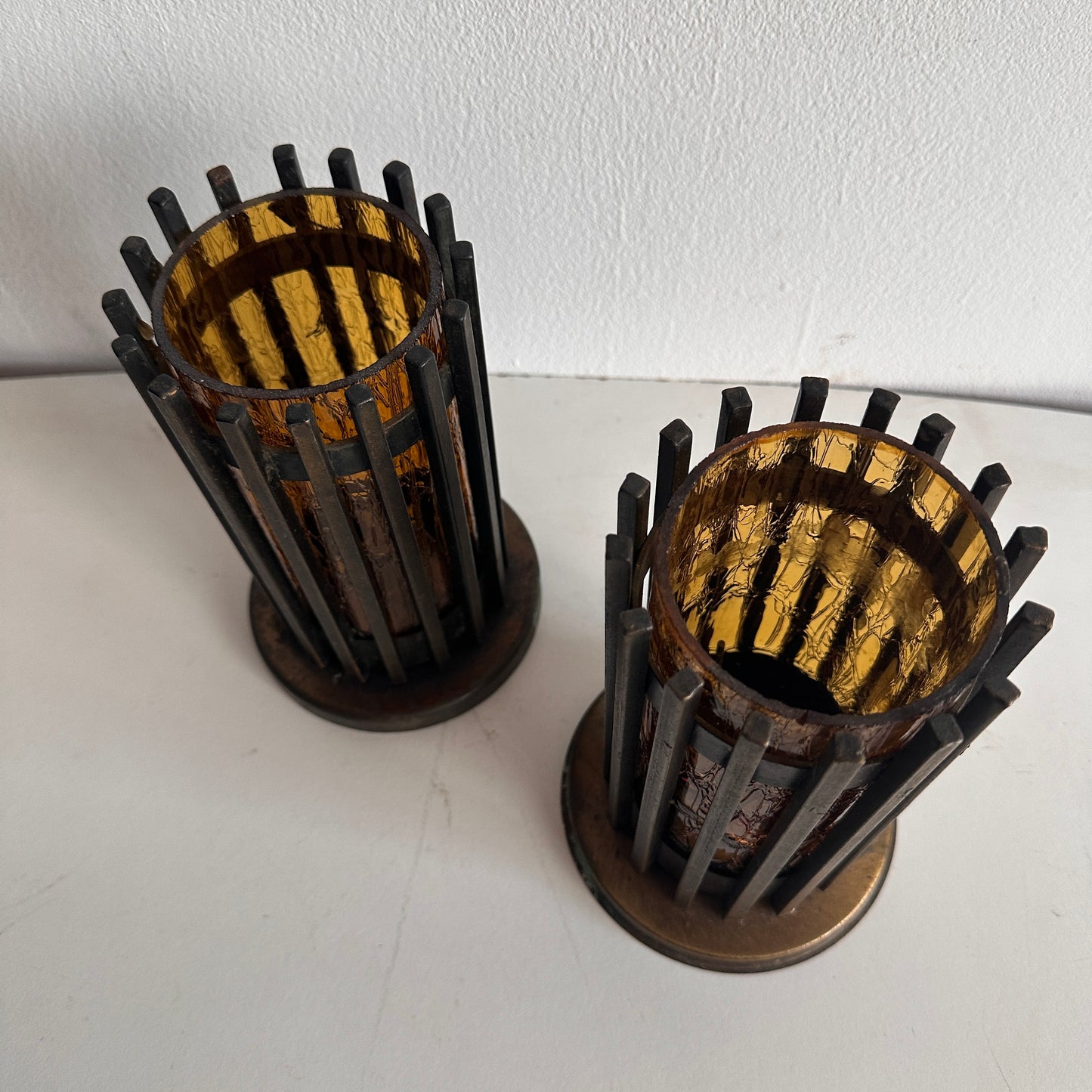 CA012 SET OF TWO BRUTALIST IRON AND AMBER TINTED GLASS PILAR CANDLE HOLDERS