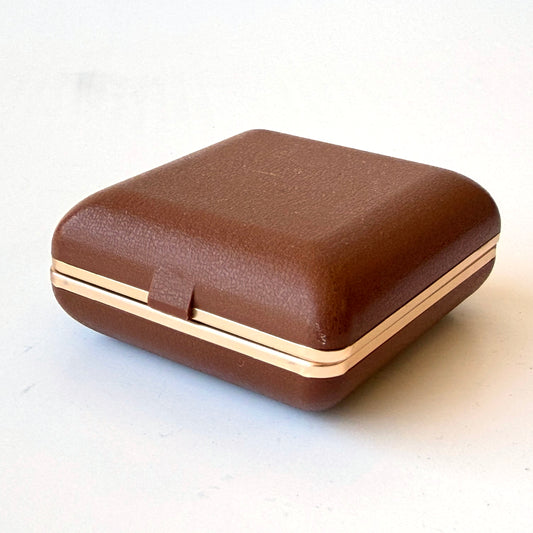 E102 BROWN PLASTIC AND BRASS FOLDING ALARM CLOCK