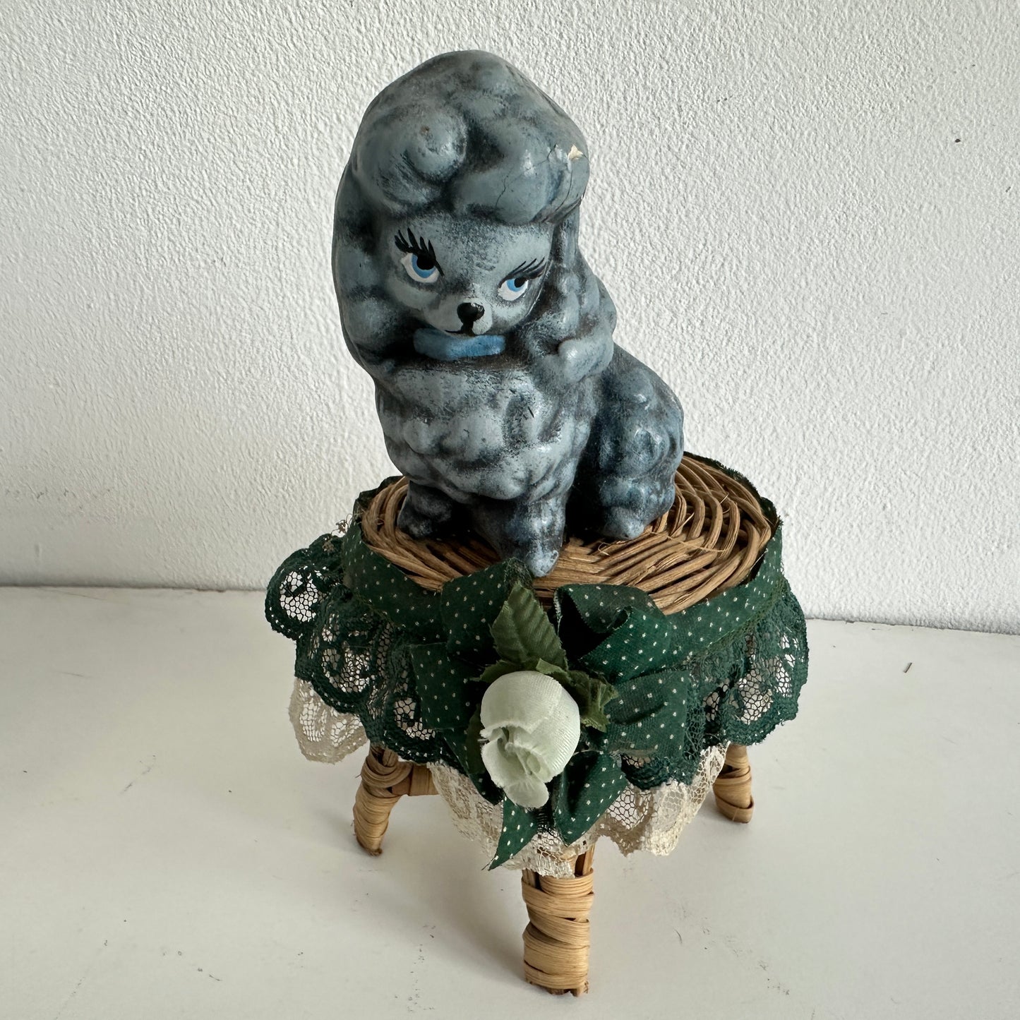 OB036 CHEEKY POODLE ON A TINY RATTAN TABLE