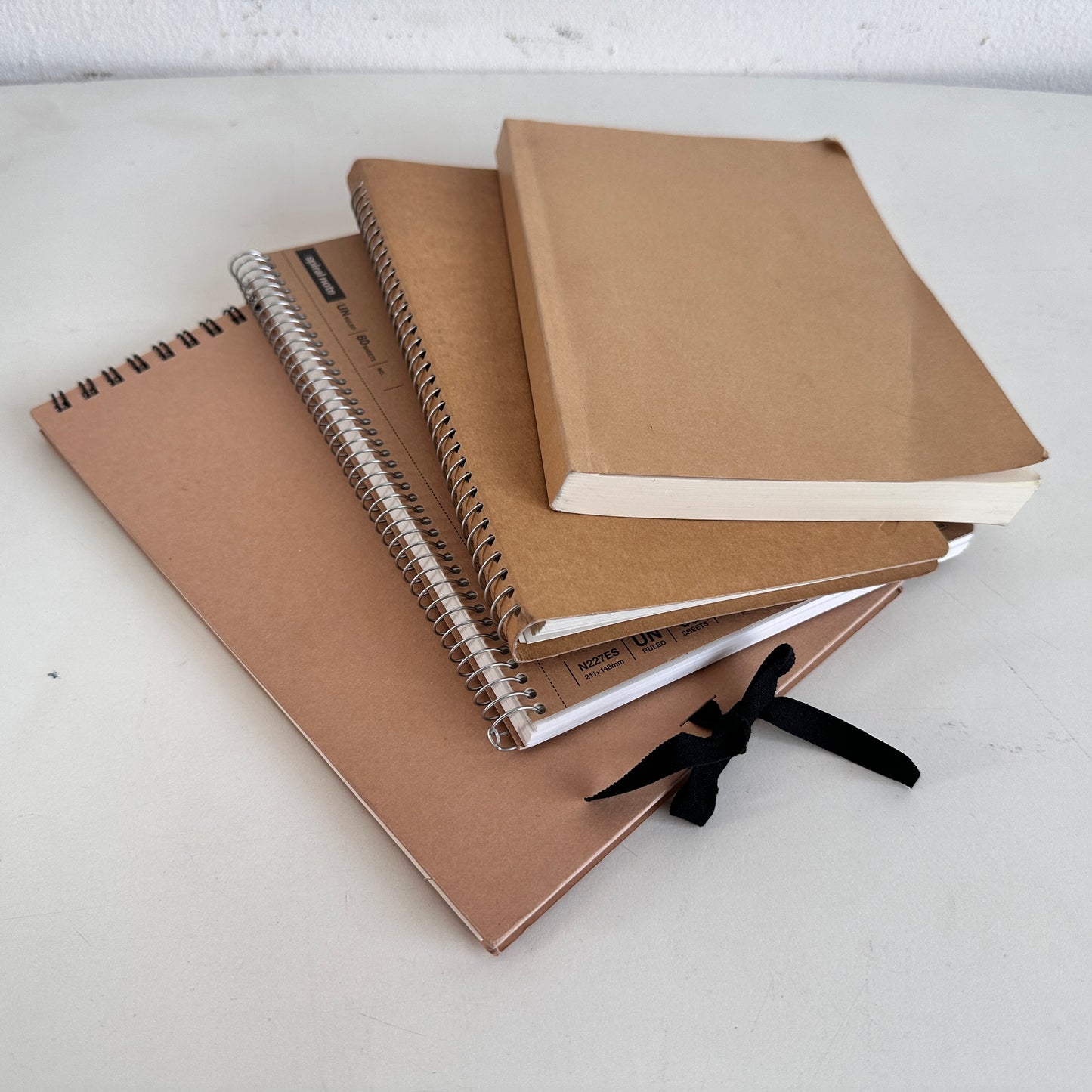 OF011 STACK OF 4 TAN NOTEBOOKS