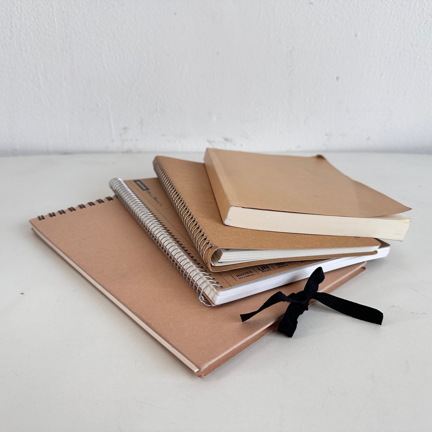OF011 STACK OF 4 TAN NOTEBOOKS