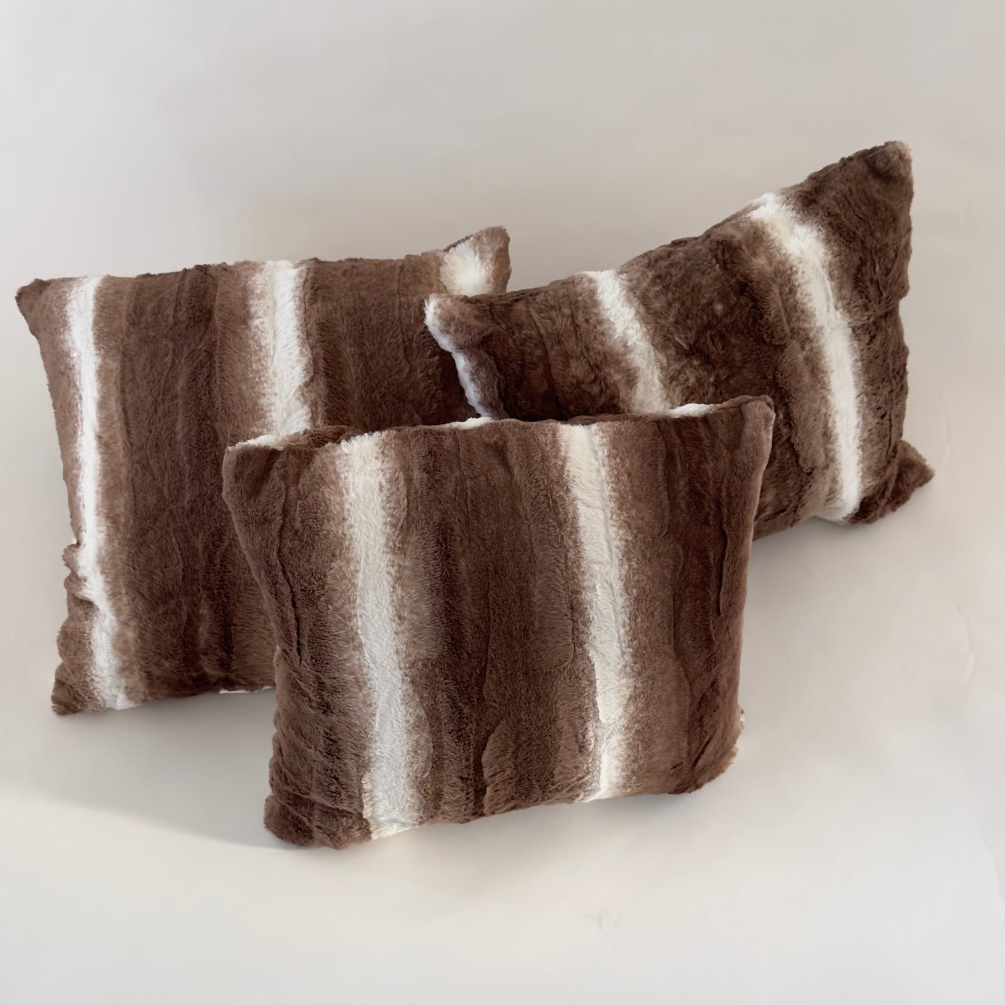 PW037 SET OF THREE BROWN AND WHITE FUR PILLOWS