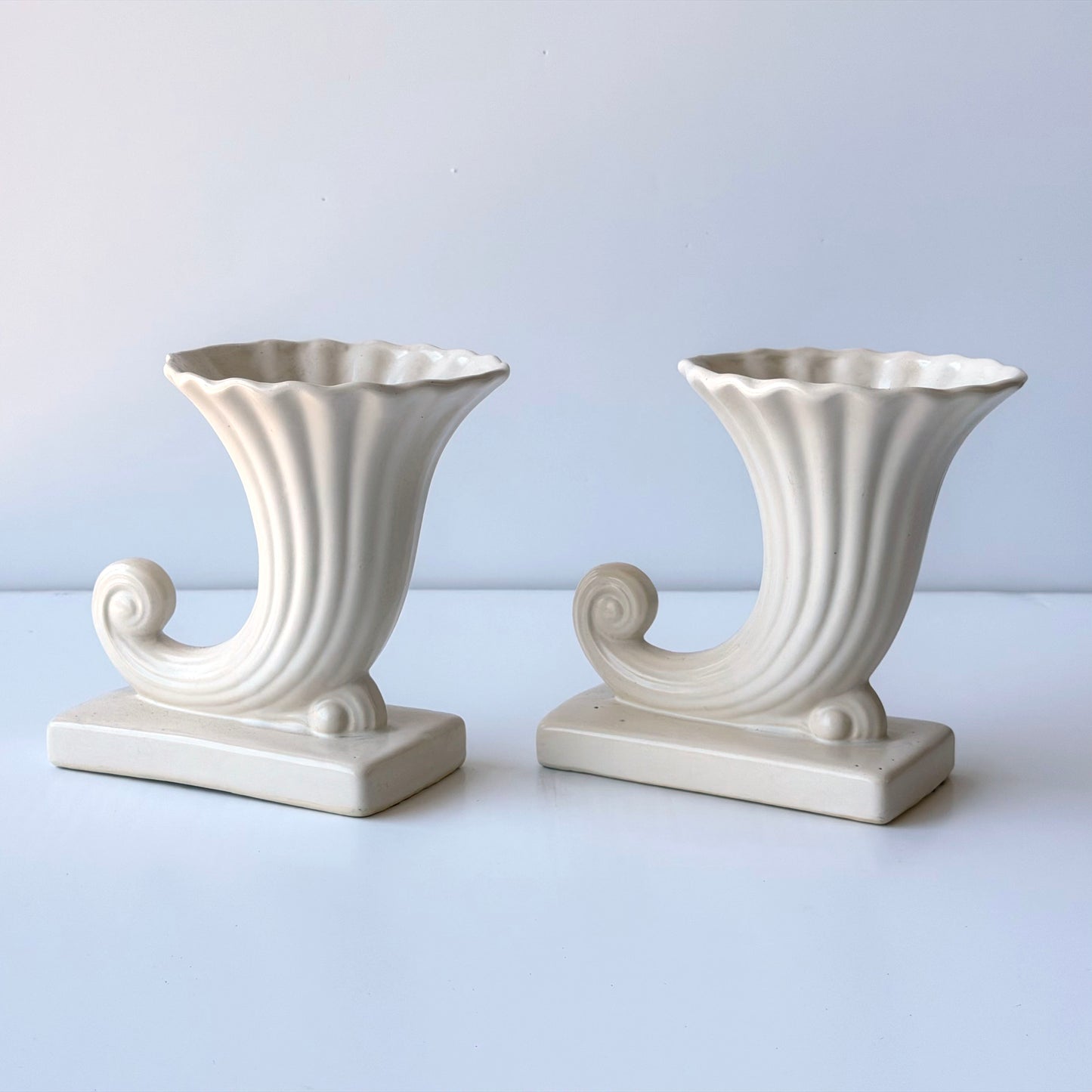 VS073 PAIR OF CREAM CERAMIC CORNUCOPIA VASES