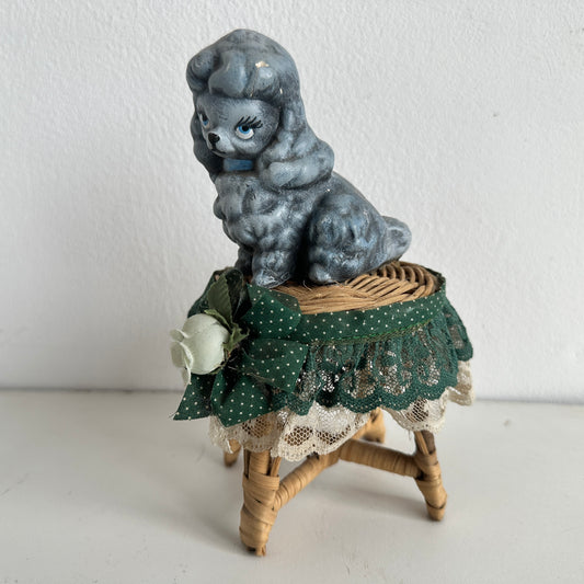 OB036 CHEEKY POODLE ON A TINY RATTAN TABLE