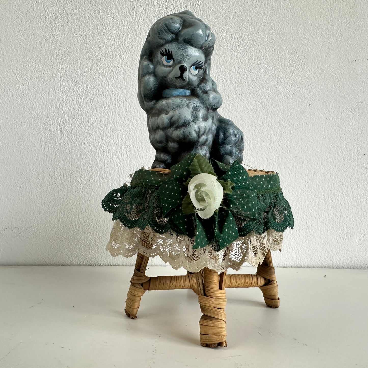OB036 CHEEKY POODLE ON A TINY RATTAN TABLE