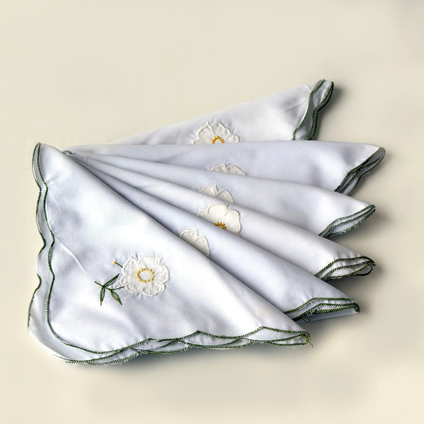 TL021 SET OF 6 WHITE FLORAL NAPKINS WITH GREEN STITCHING