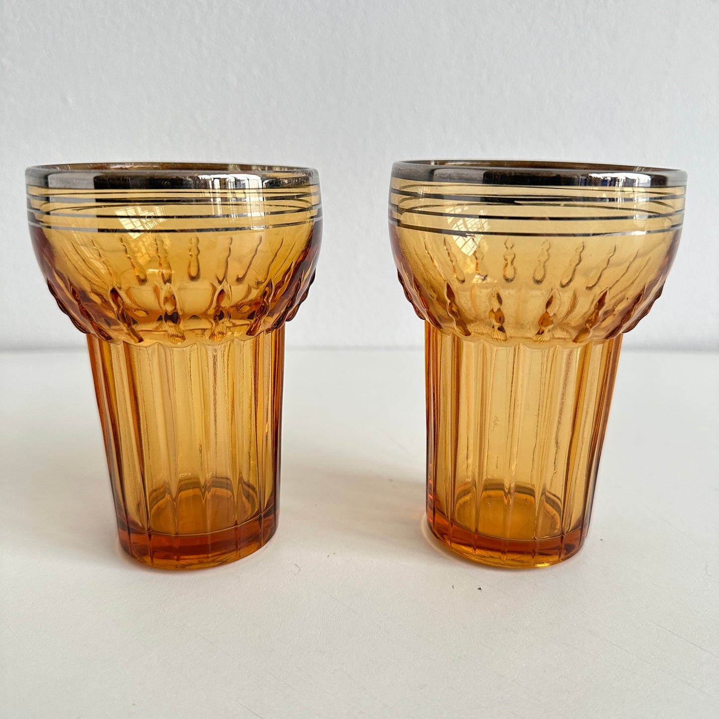 TT155 PAIR OF AMBER TUMBLERS WITH SILVER RIMS